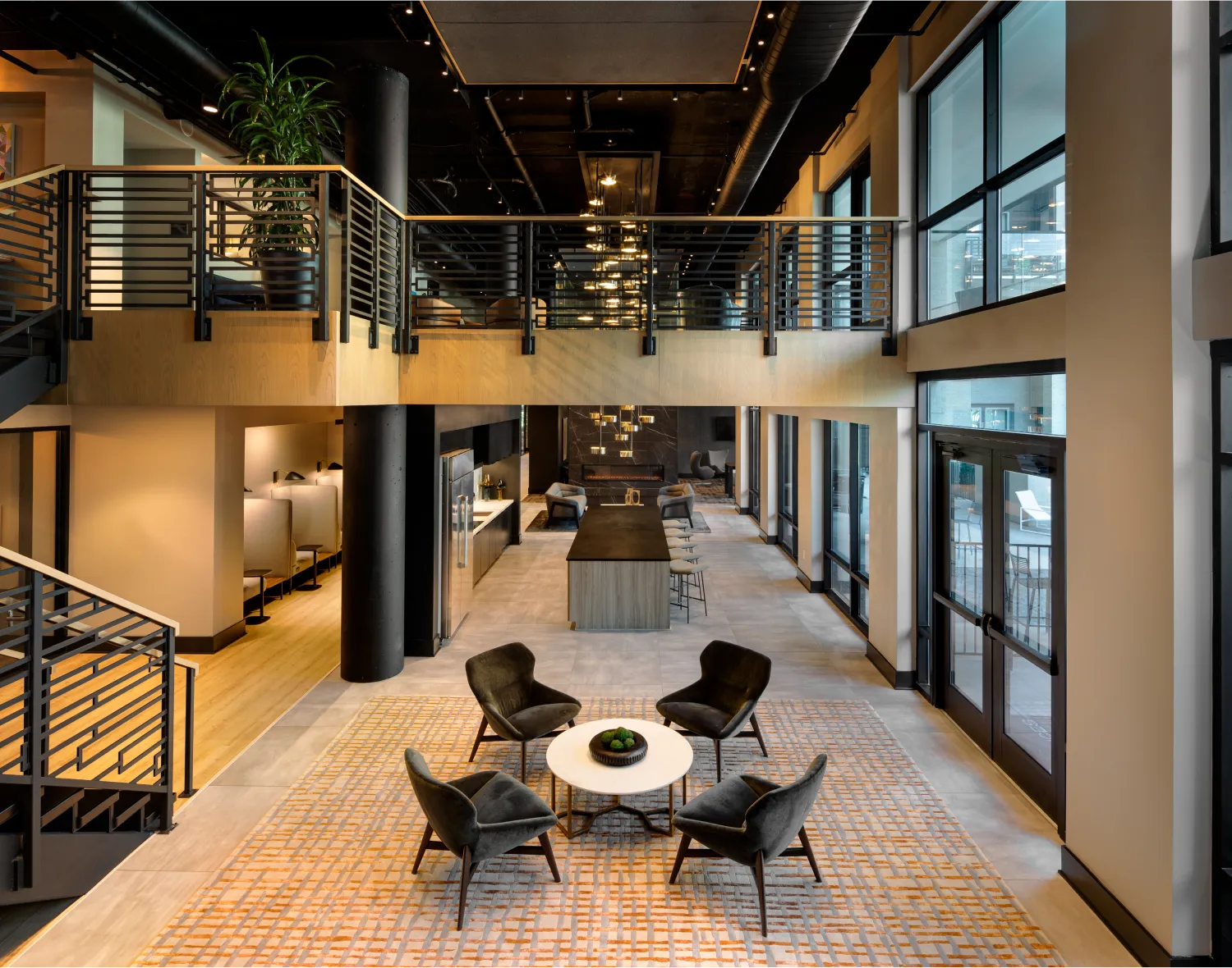 High-end residential lounge featuring a two-story layout, sleek seating, and contemporary decor