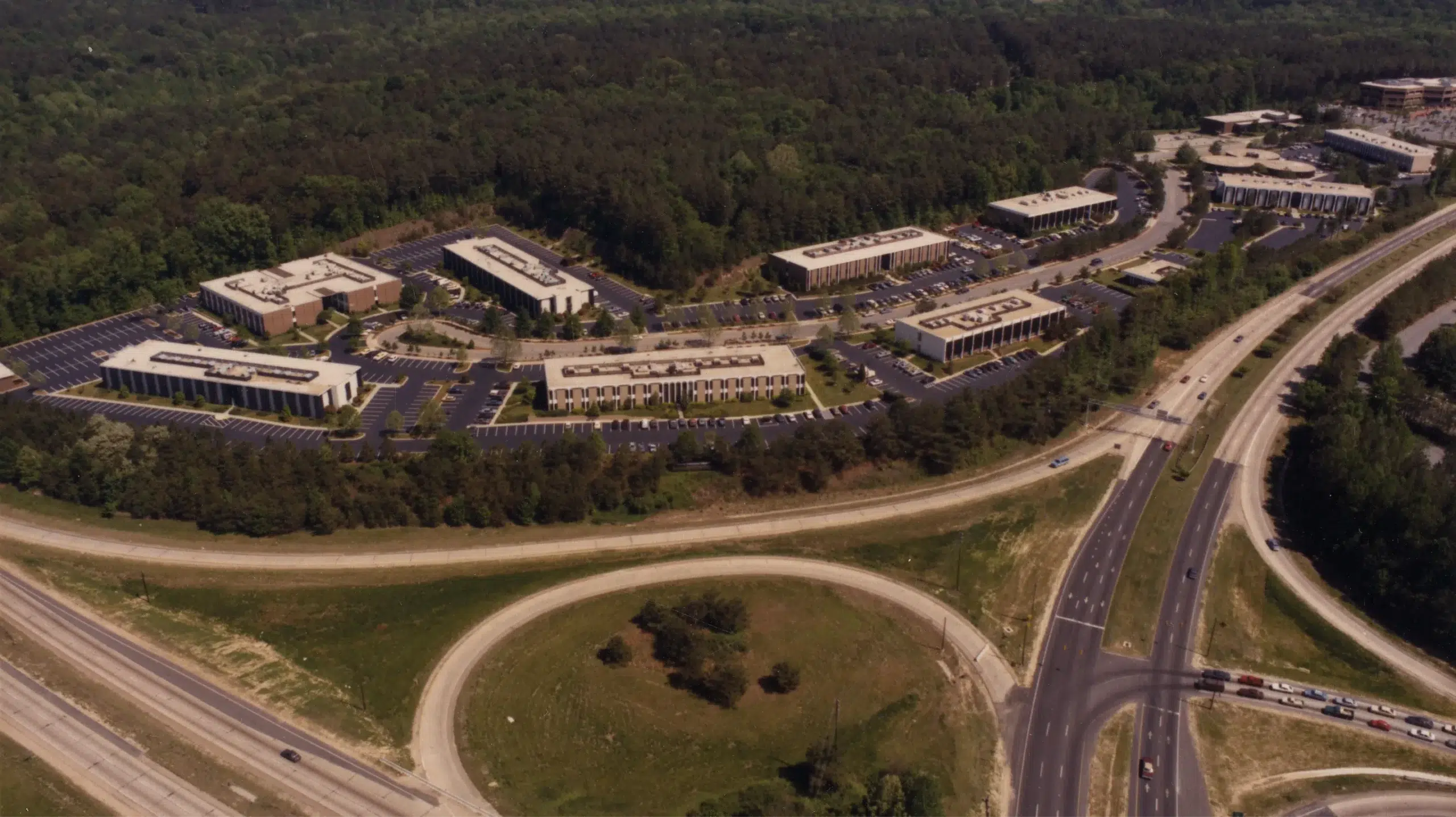 1970s aerial image showing early Glenwood Place development surrounded by forest