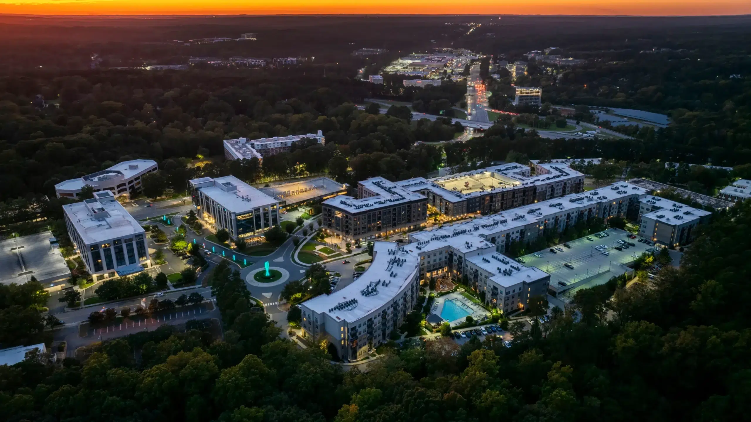 Modern aerial view of Glenwood Place at dusk with illuminated buildings and streets
