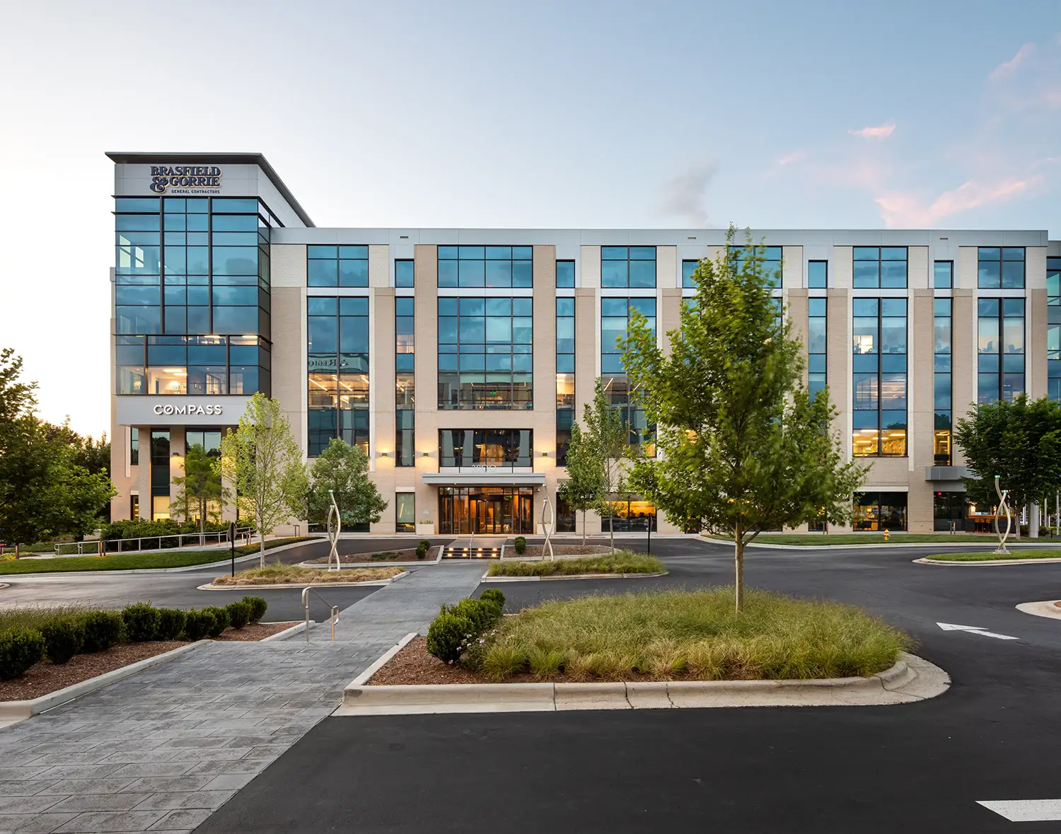 Brasfield & Gorrie office building with modern glass facade at sunset