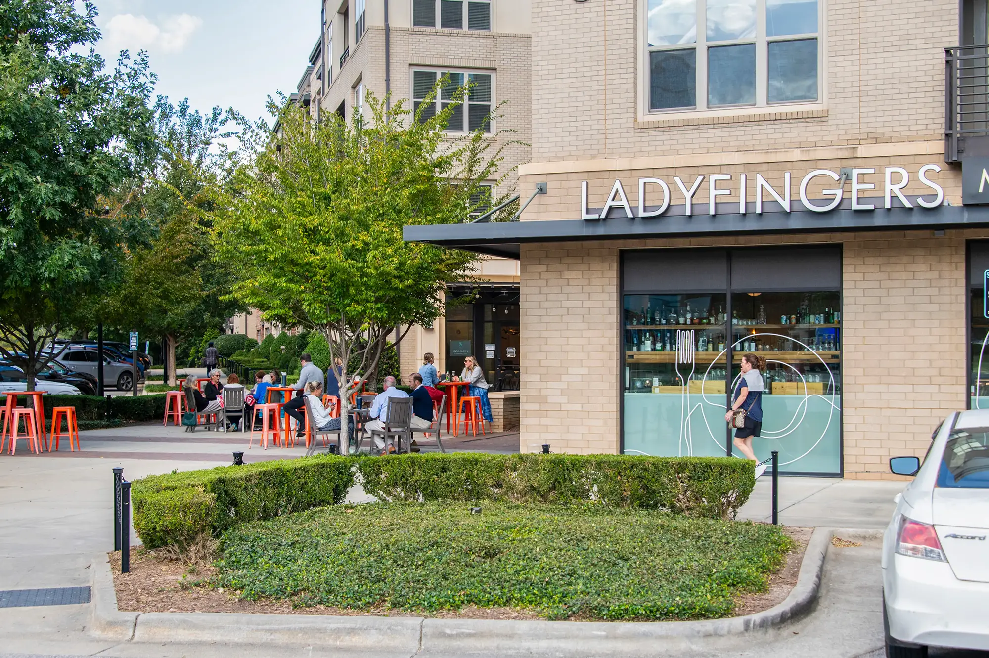 Outdoor café seating at Ladyfingers Market & Eatery on a sunny afternoon